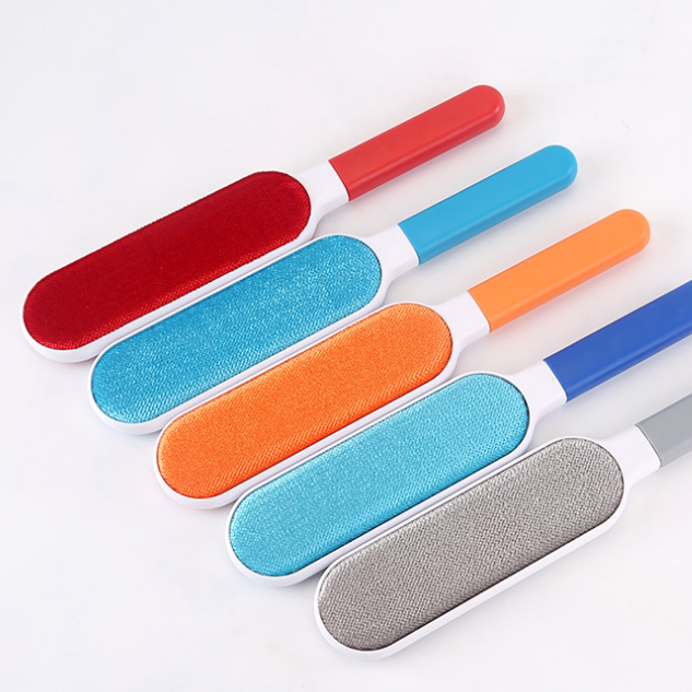 Set of five pet grooming brushes with different colored bristle designs on a white background