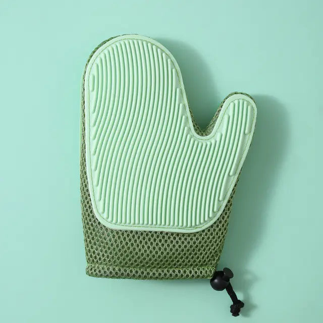 Green textured oven mitt on a light green background