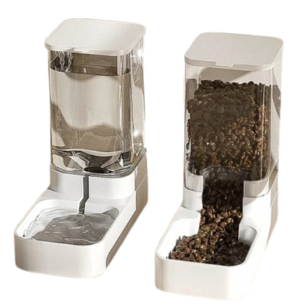 Two transparent pet feeders with water and food compartments on a white background