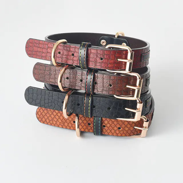 Stack of leather dog collars in various colors on a light gray background