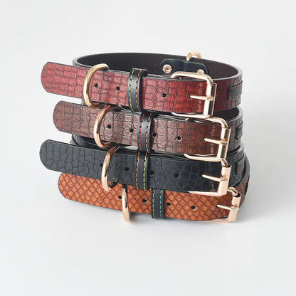 Stack of leather dog collars in various colors on a light gray background