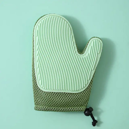 Green textured oven mitt on a light green background